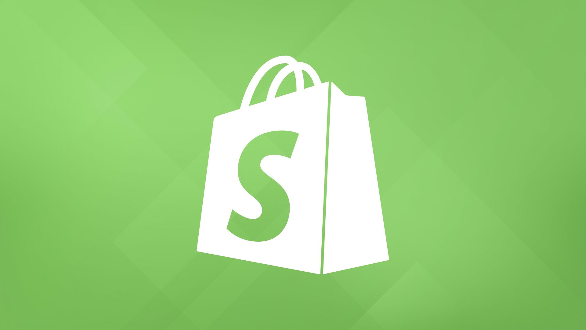 A person working on a laptop with the Shopify logo displayed on the screen, representing setting up an eCommerce business.