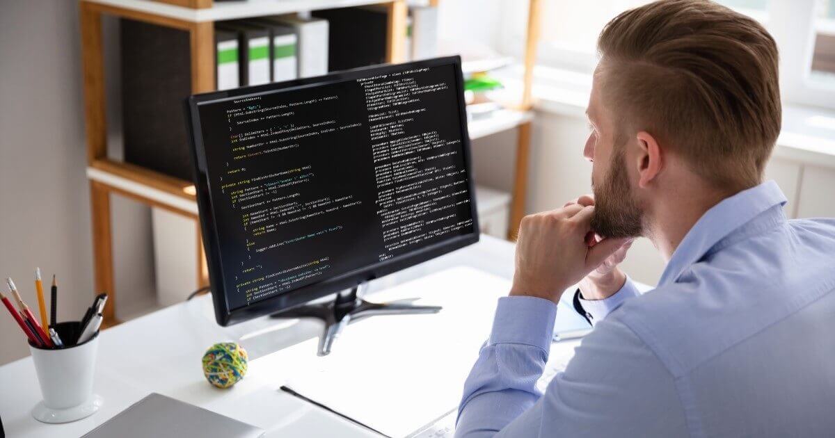 A person using a laptop, representing regular software development.